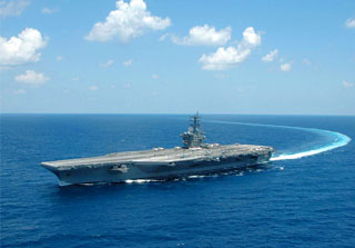 Photo of an aircraft carrier turning